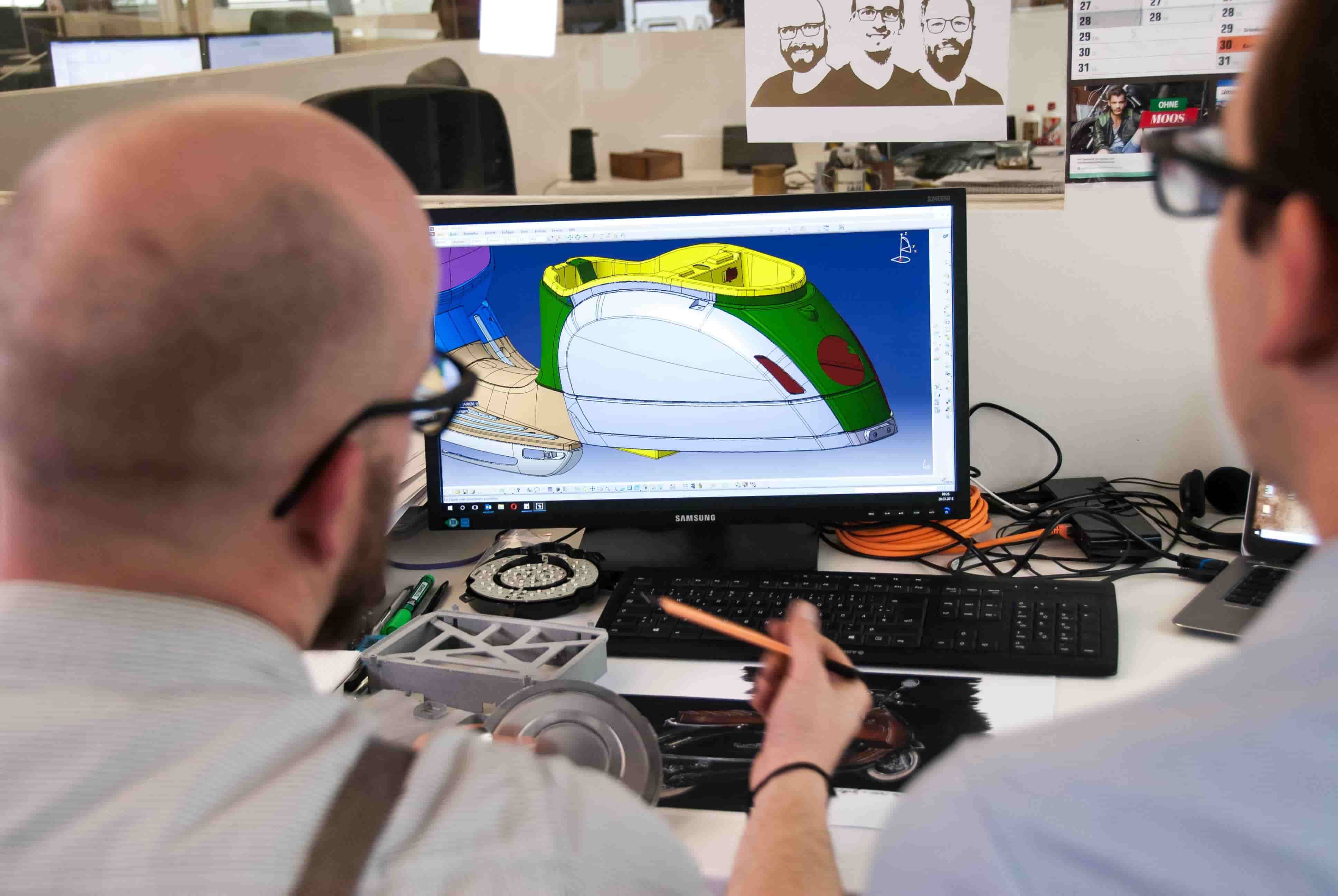 Architects watching a 3d model on a computer