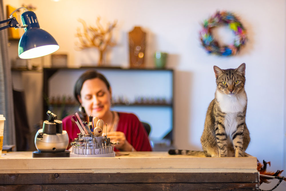 Cat and woman in jewelry studio