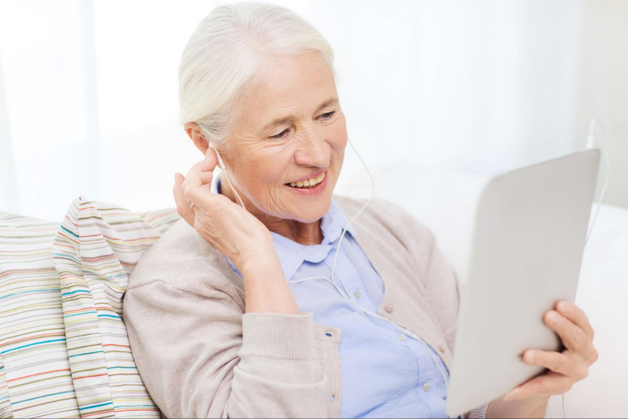 hearing test app: old woman watching in a tablet