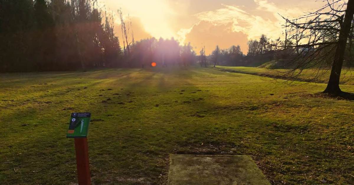 a tee pad with a sunset view