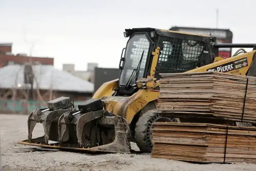 Skid steer with a grappler bucket attachment