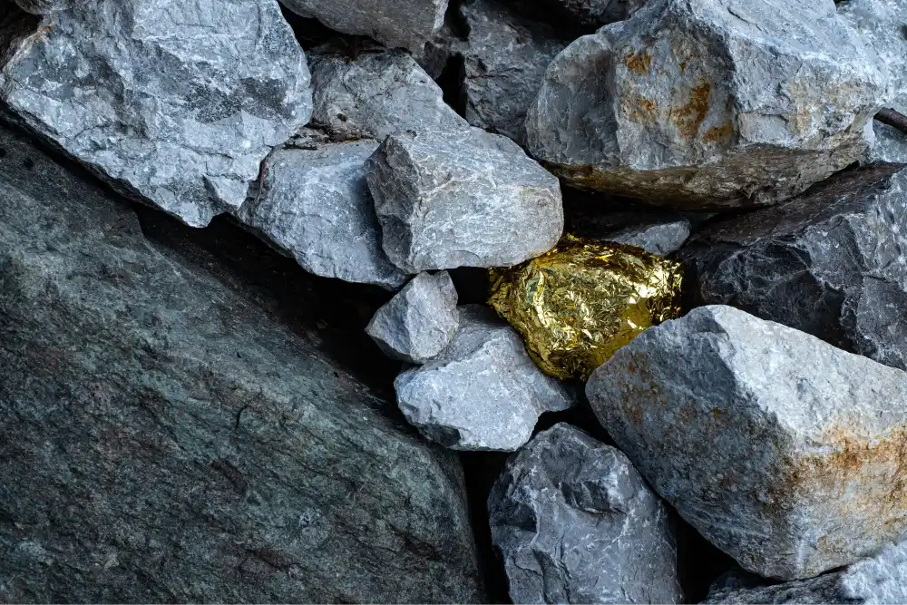 Gold nugget hidden in rocks representing untapped value within operational inefficiencies