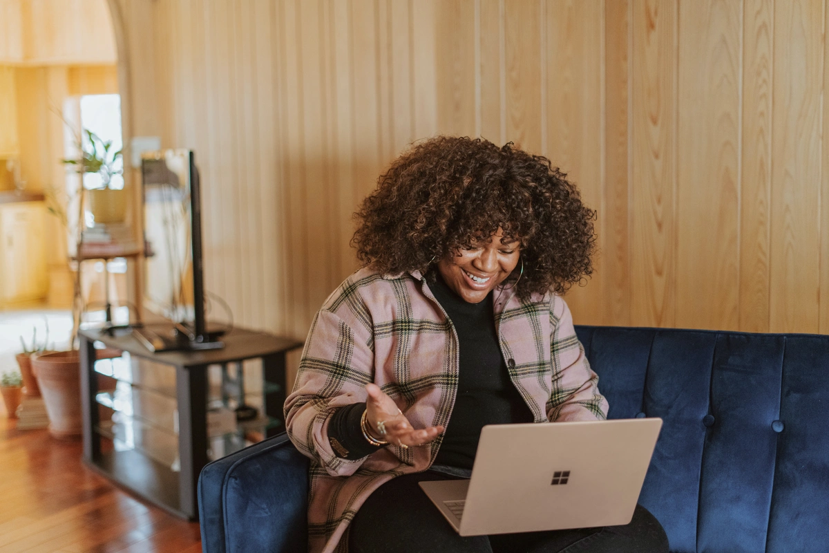 Lady smiling at home on her laptop