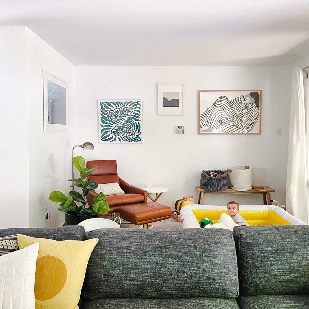 frames in living room with baby in kiddy pool
