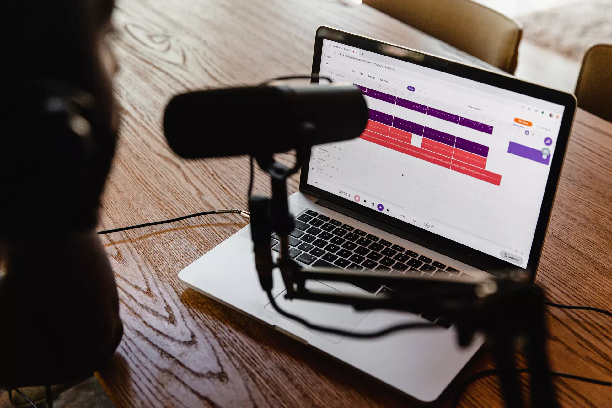 Stock photo of a man recording a podcast episode on his laptop