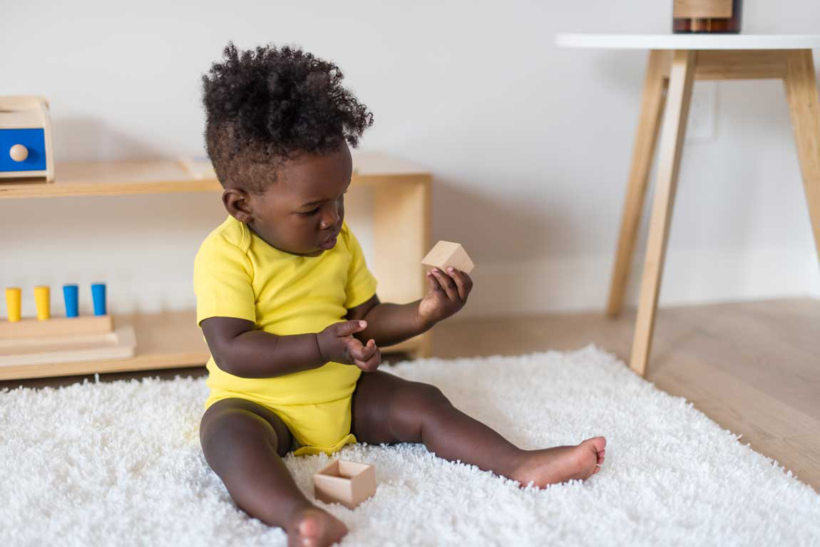 baby playing with wooden blocks