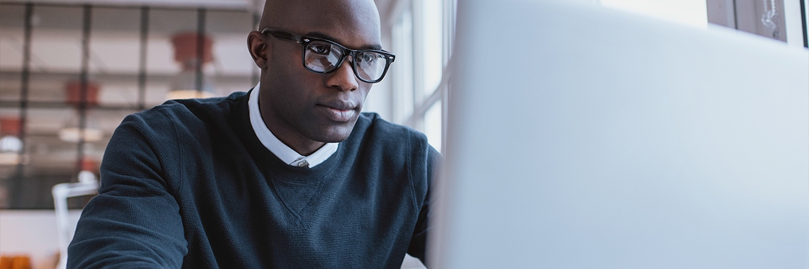 Man staring at his laptop screen.