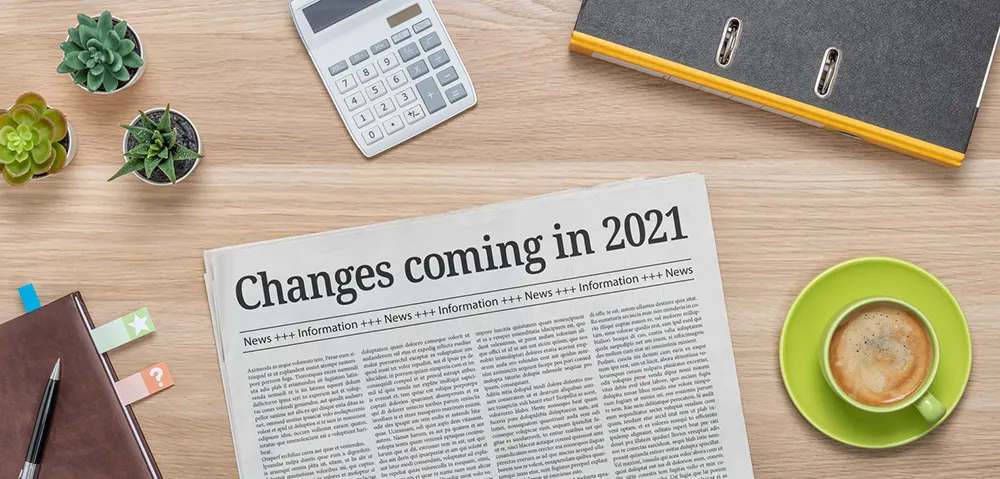 newspaper on desk saying changes coming in 2021
