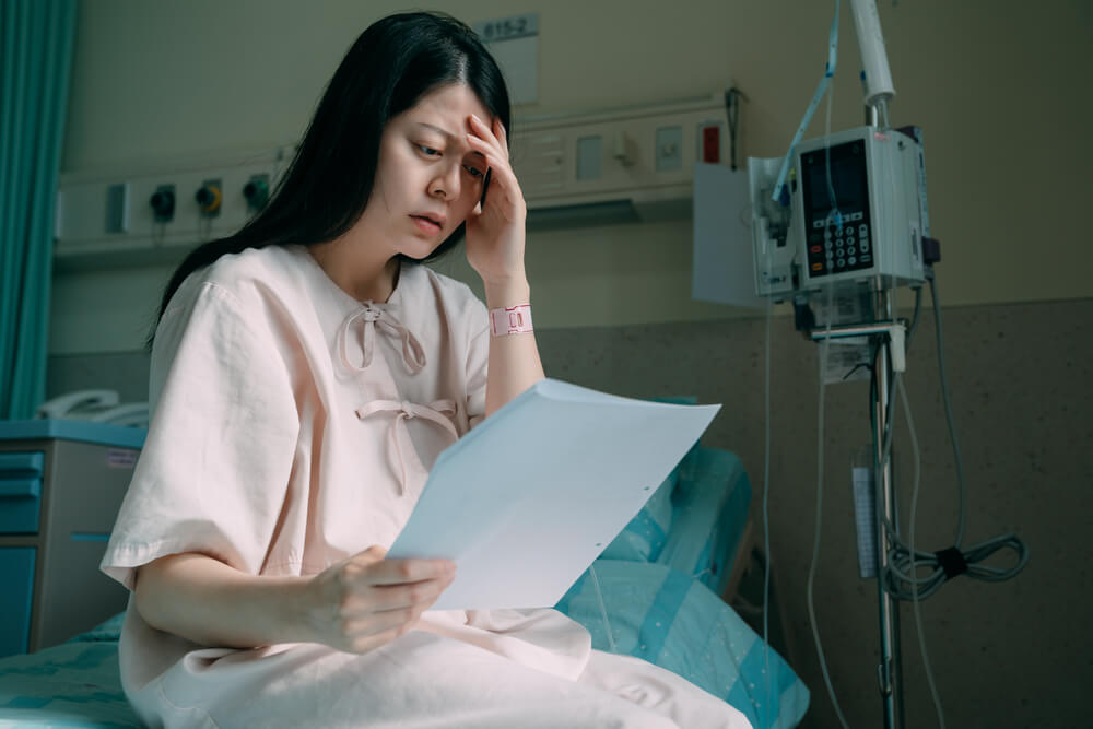 Woman wondering how she will cover the cost of her medical treatment