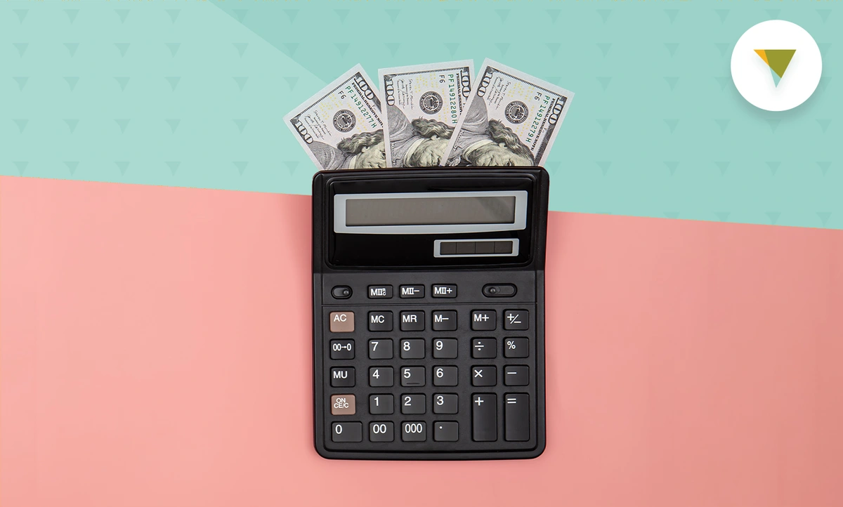 Calculator with money fanned out behind it
