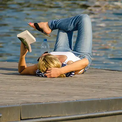 Woman reading book on a mental retreat.