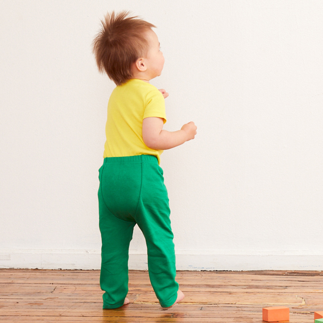 a toddler wearing green cloth diaper pants from primary.com