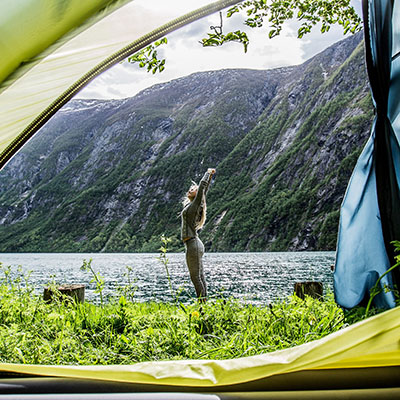 Woman stretching at camp site.