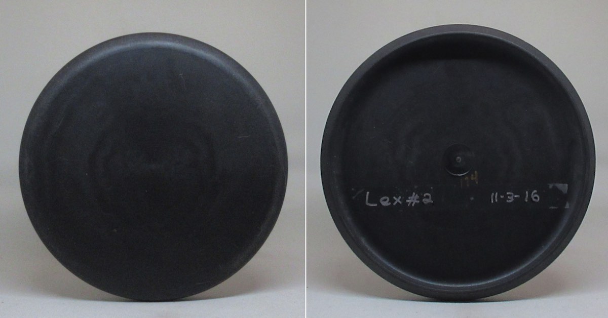 A black disc golf putter seen from top and bottom.