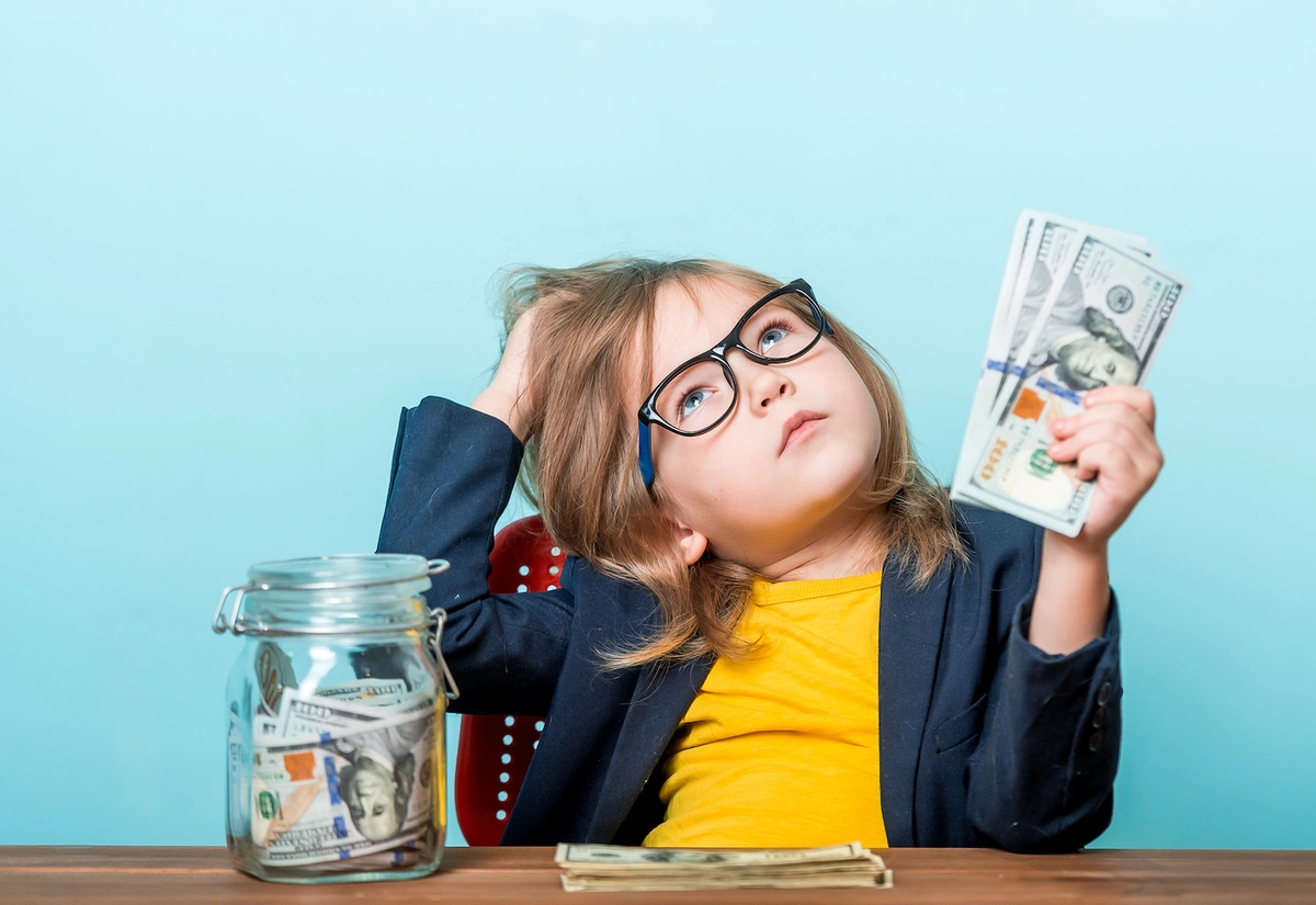 little girl holding money wondering if long-term care insurance is worth it