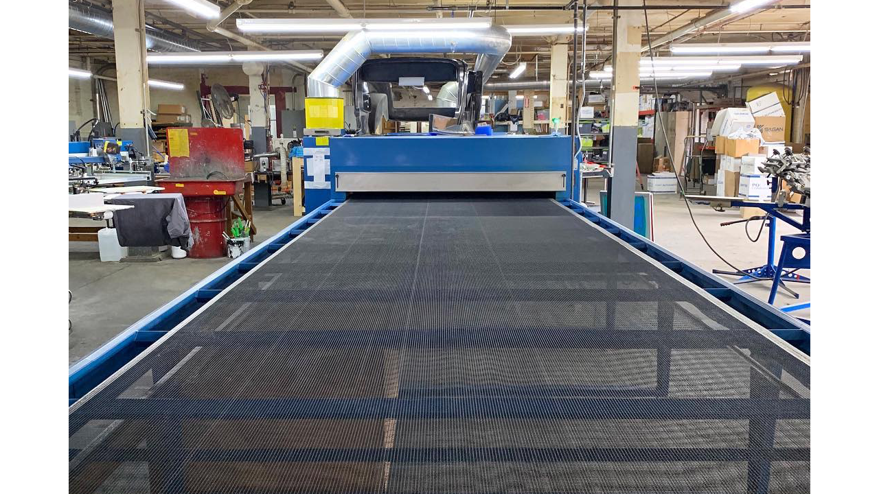A conveyor dryer for screen printing at Brat Printing.