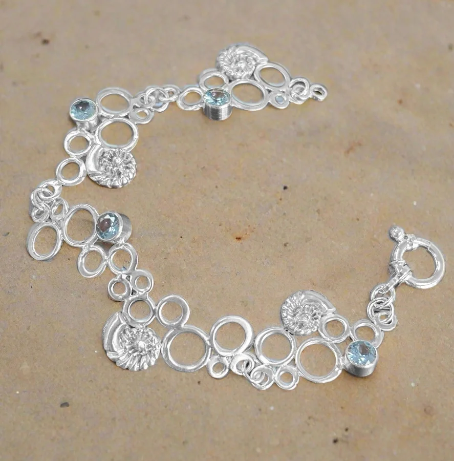 Silver clay undersea themed bracelet with bubble links, blue stones, and shells made from metal clay