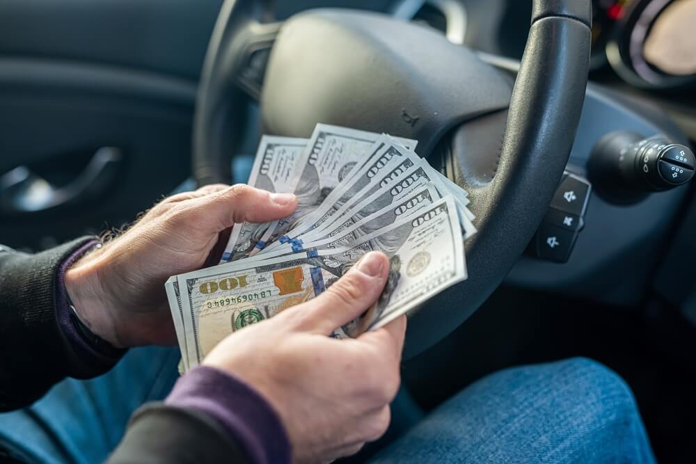 counting title loan cash in car