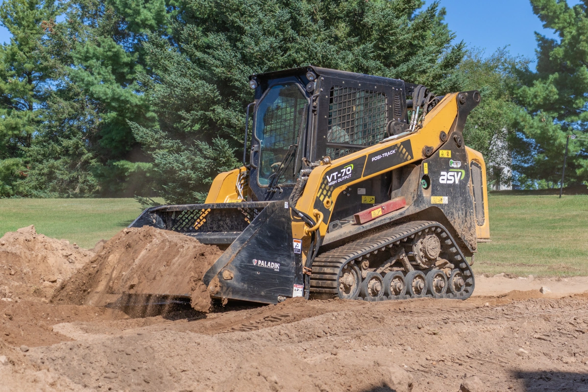 AS VT-70 compact track loader moving dirt around a job with trees in the background