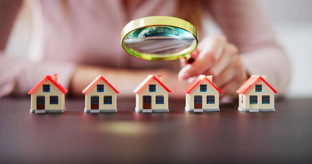 Drawing of houses with a magnifying glass over them