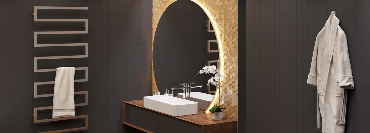 black painted walls in a vanity room. Above vanity there is a white sink, large round mirror, and a gold scale accent wall. 