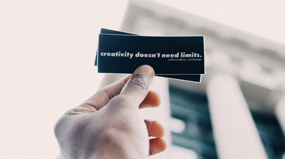 Person holding Creativity Doesn't Need Limits sticker