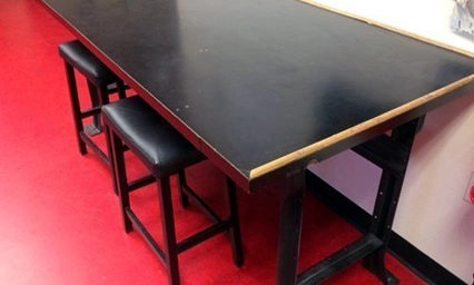 image of a black table with two stools