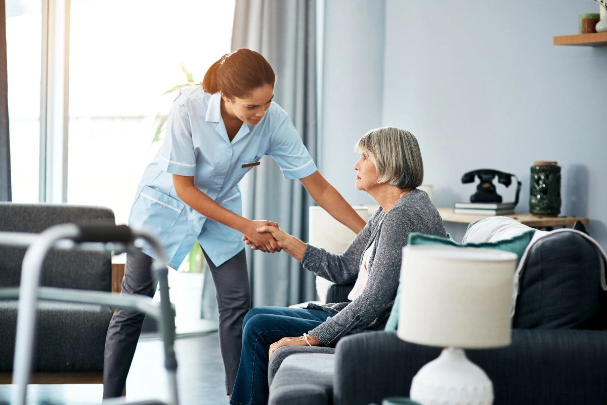 long term care aide helping patient