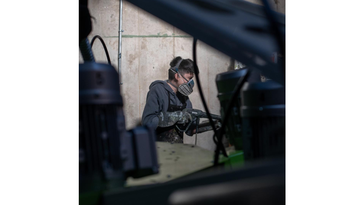 A worker reclaiming screens for screen printing.