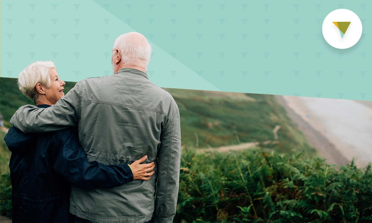 Elderly couple hiking through the forest