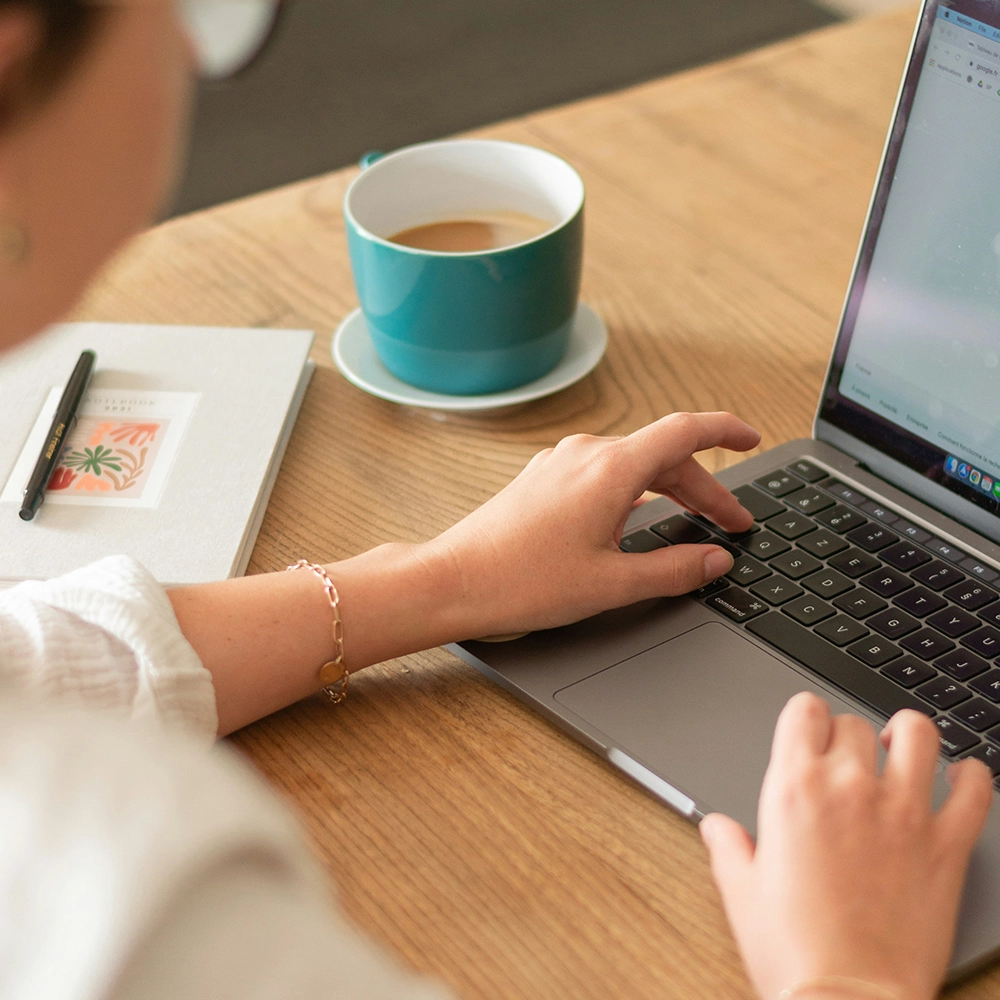 Person saving documents on a laptop.
