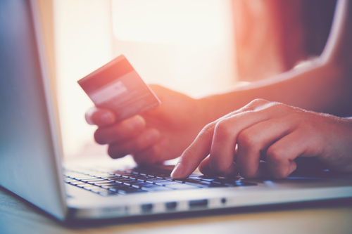 Woman inputting credit card details onto laptop