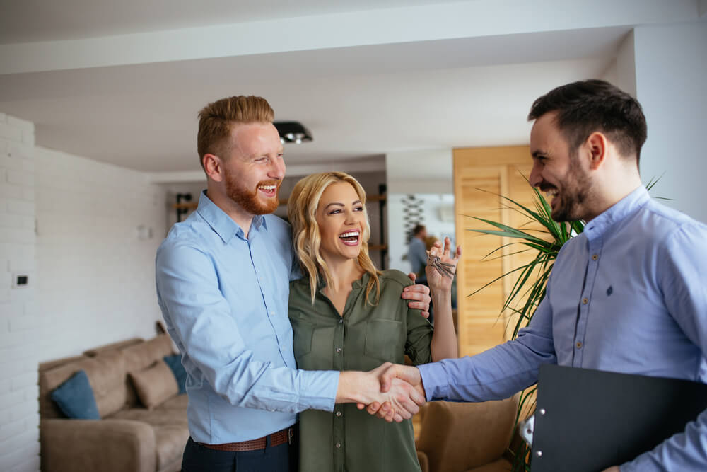 Couple shaking hands with a title loan agent