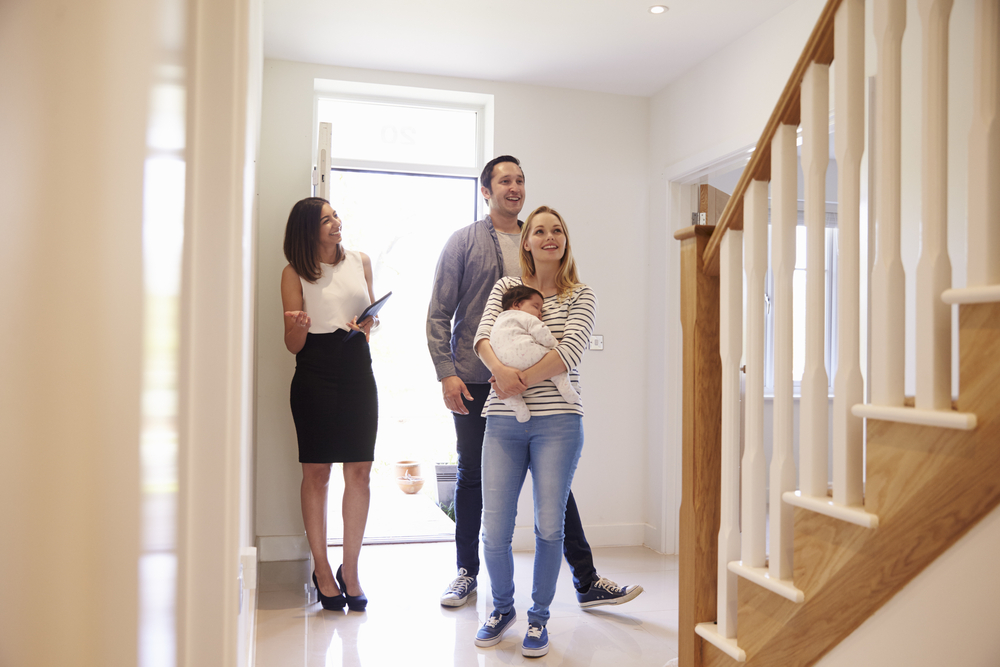 Young family being shown around a new home