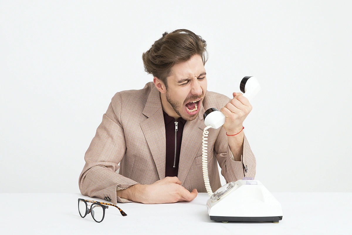 A man yelling at the phone.