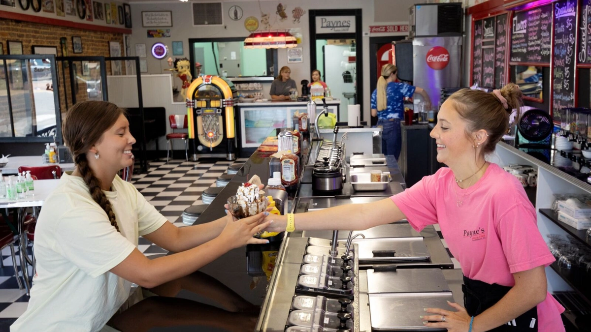 Women smiling and exchanging ice cream