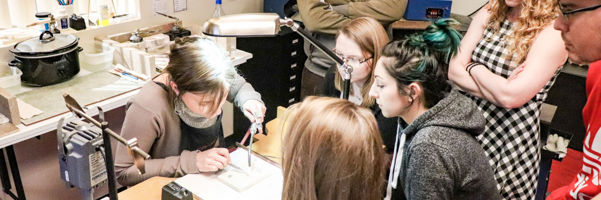 Employees learning metalsmithing at Halstead