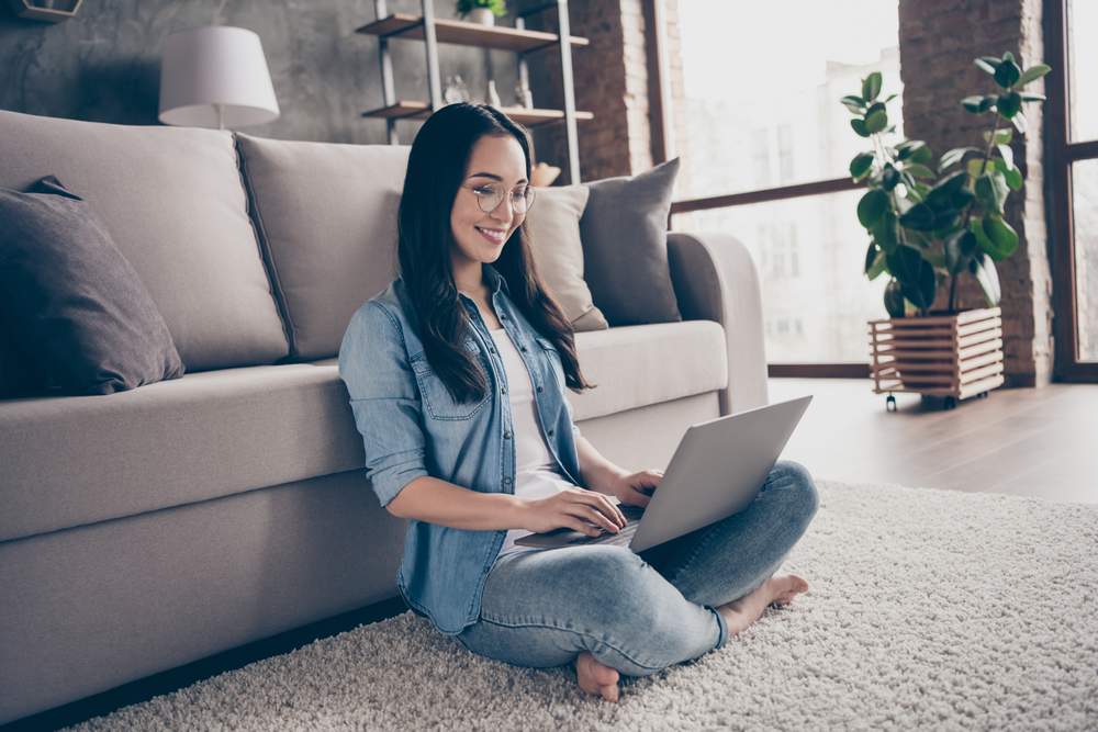 woman checking on laptop in lounge