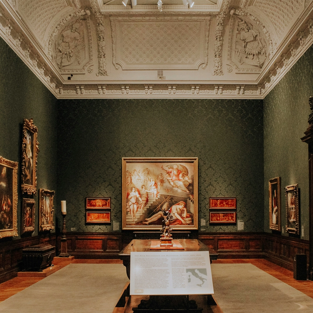 An ornate art museum with paintings.