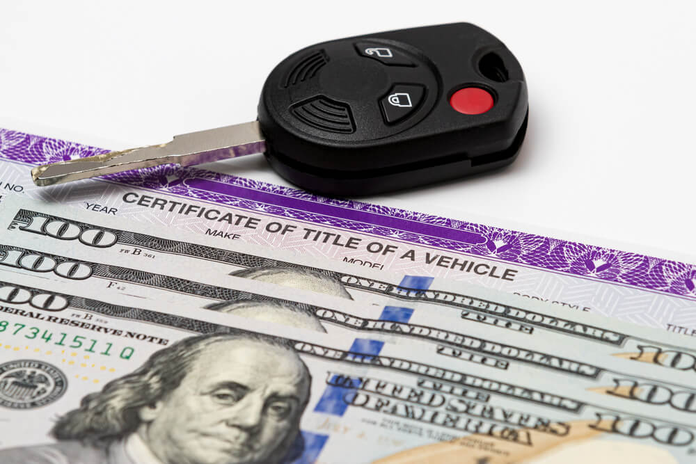 car key with cash and title loan paperwork