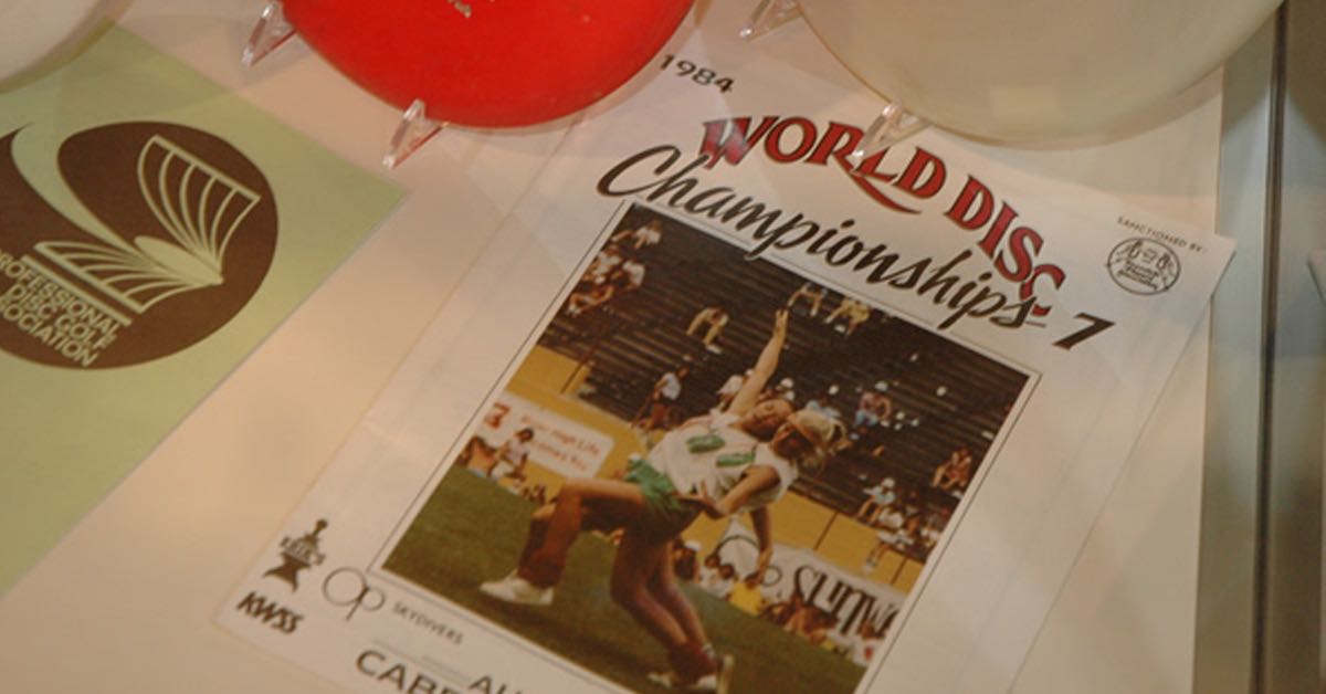 Flyer for the World Disc Championships with a photo of women in 80s clothes