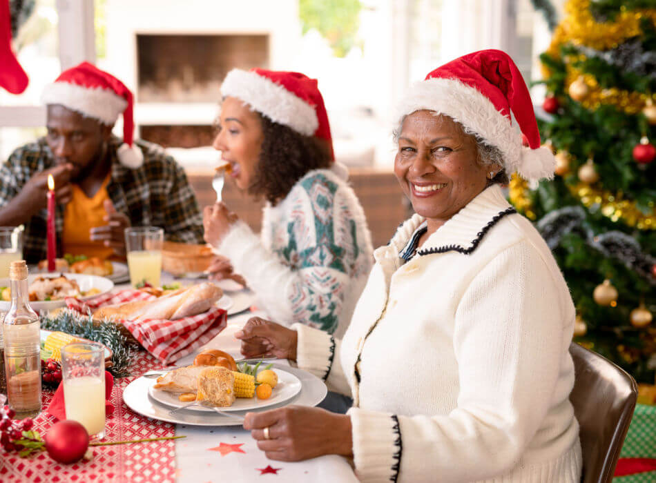 A grandmother practices self-care during the holidays while at family dinner.