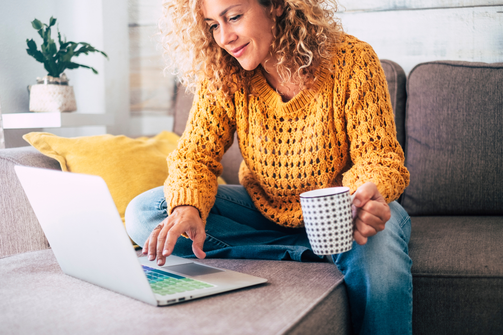 Woman on laptop drinking coffee