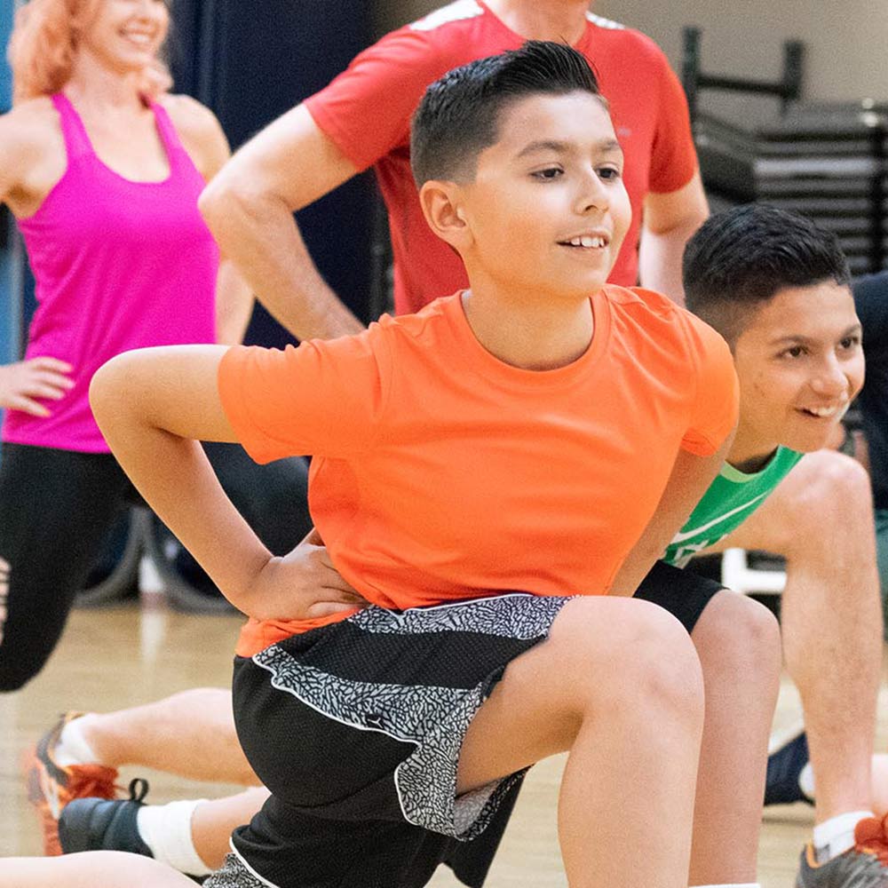 kids and adults in a group fitness class