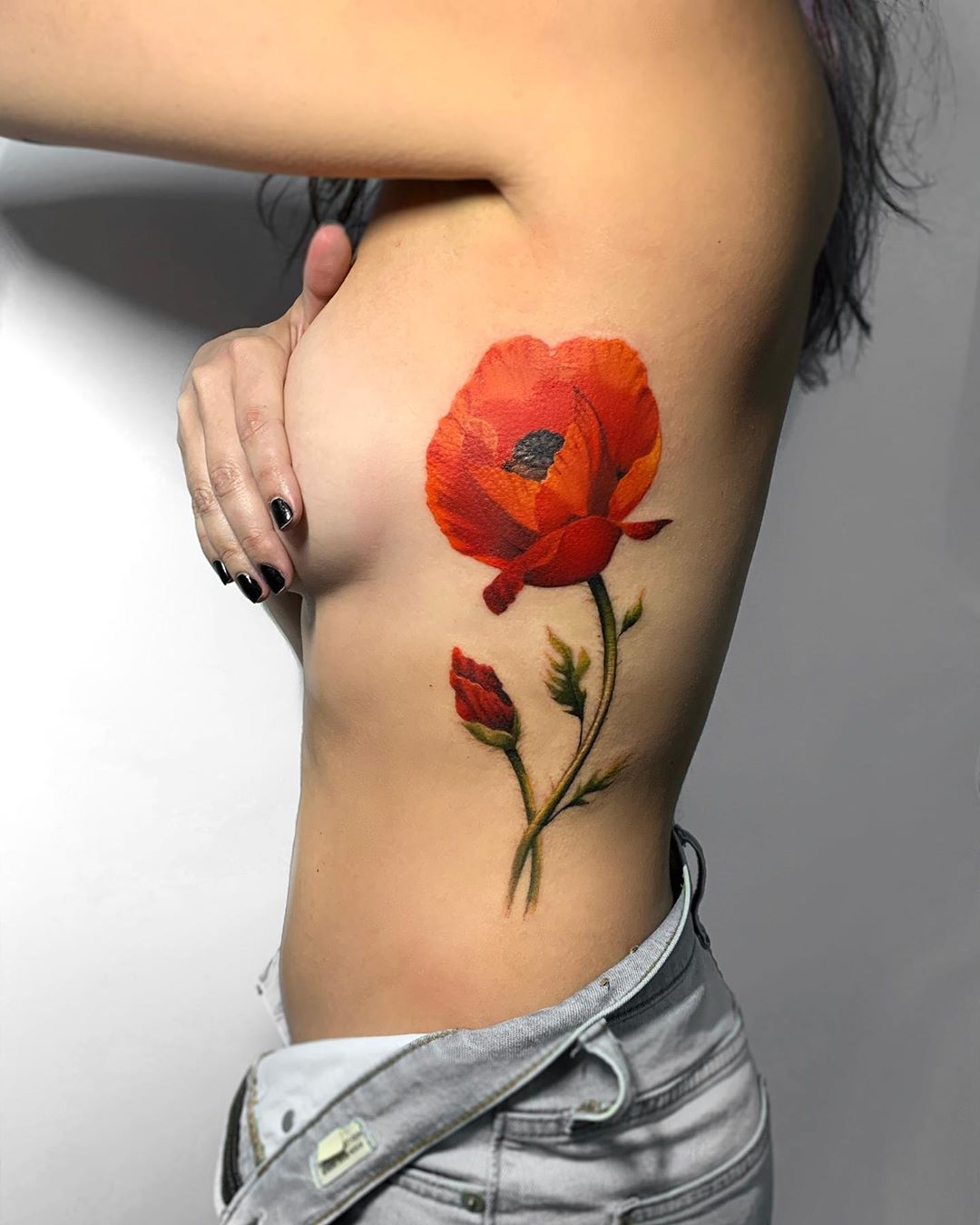 Poppy flower tattoo on ribs