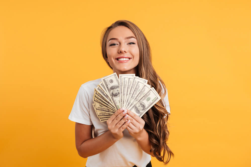 woman happy with cash