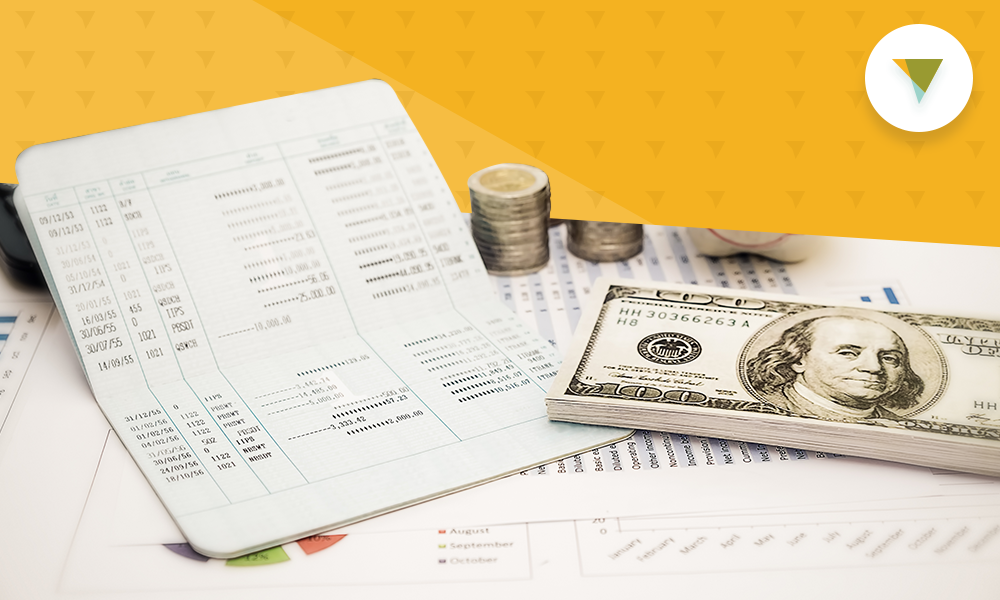 Stack of money beside bills.