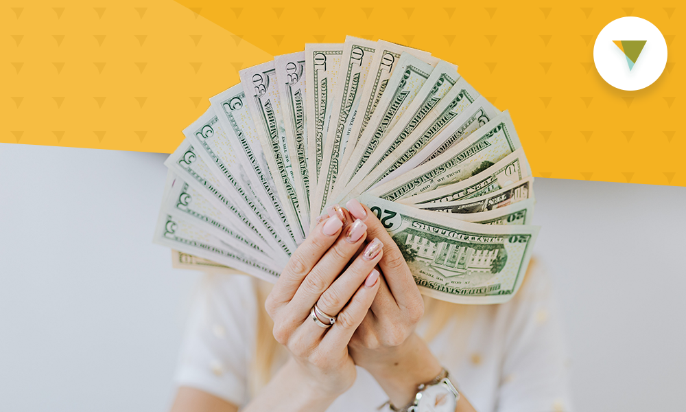 Woman fanning stack of money.
