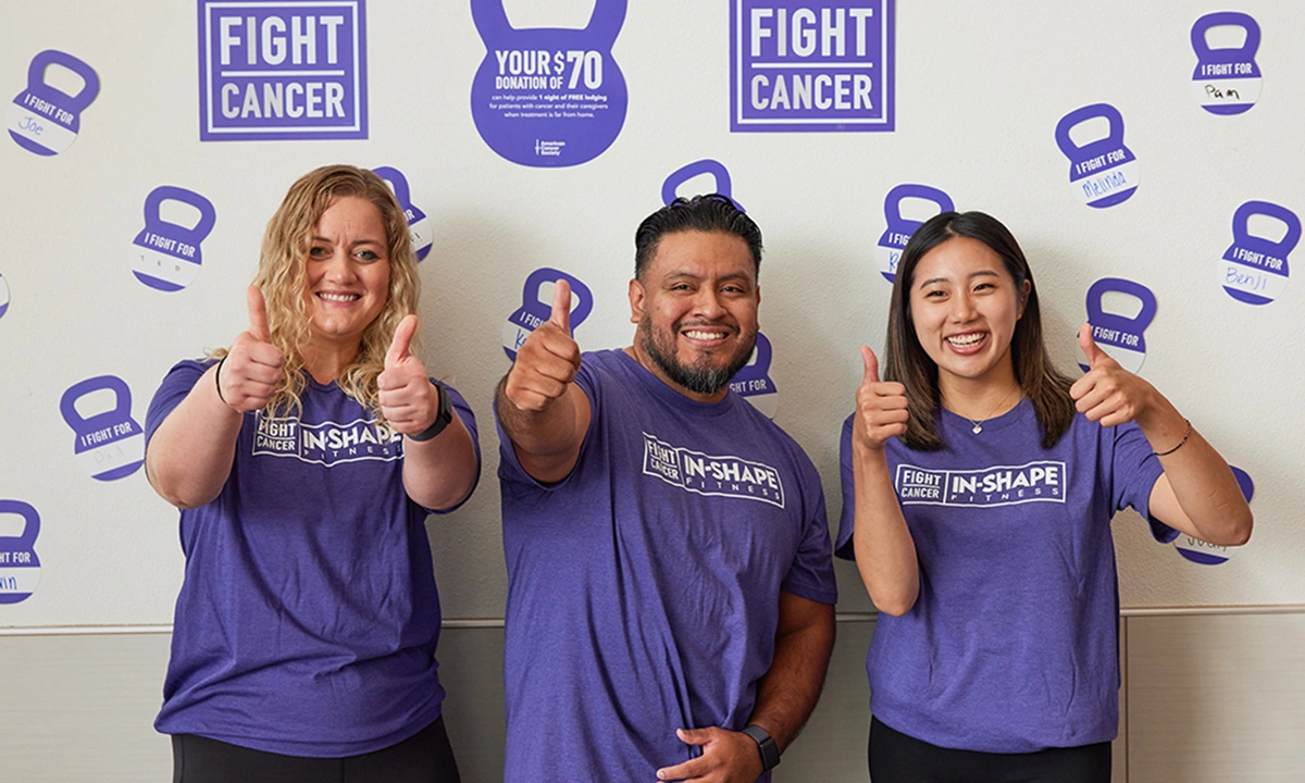 In-Shape team members holding a thumbs up