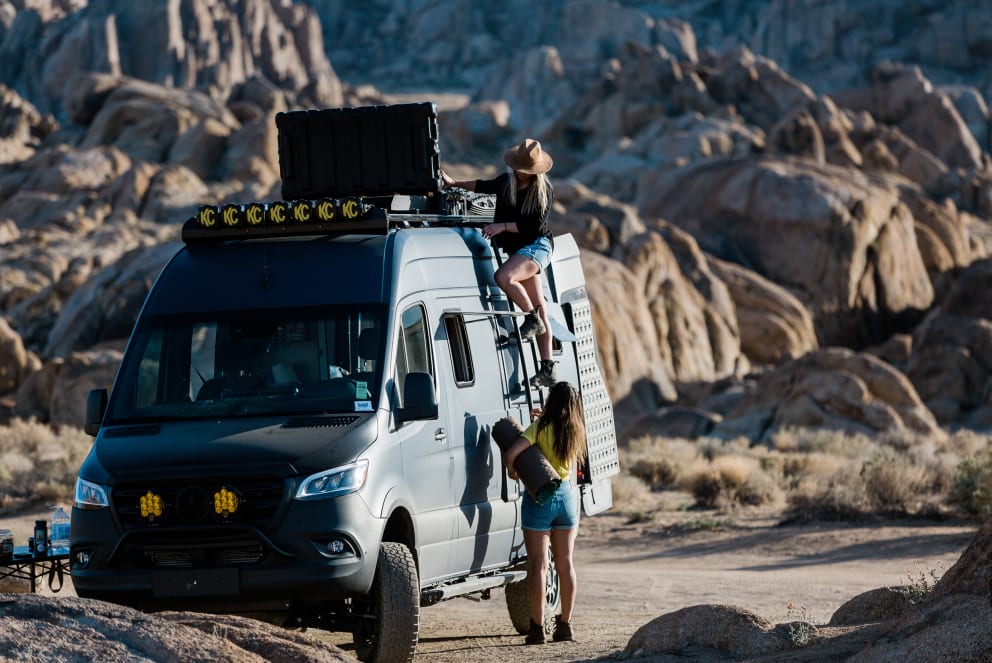 women climning latter of revel rv in california